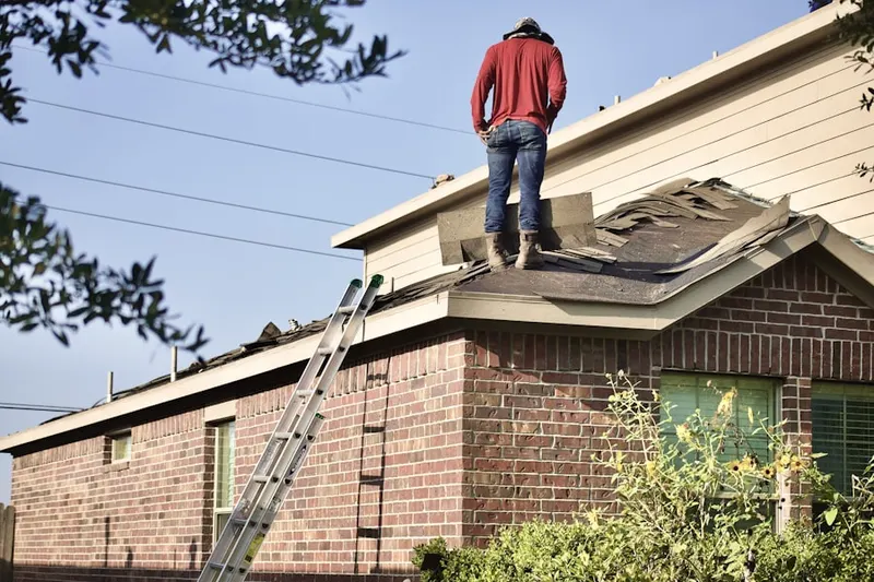 Professional roofer working on a residential roof in The Cultural Arts District